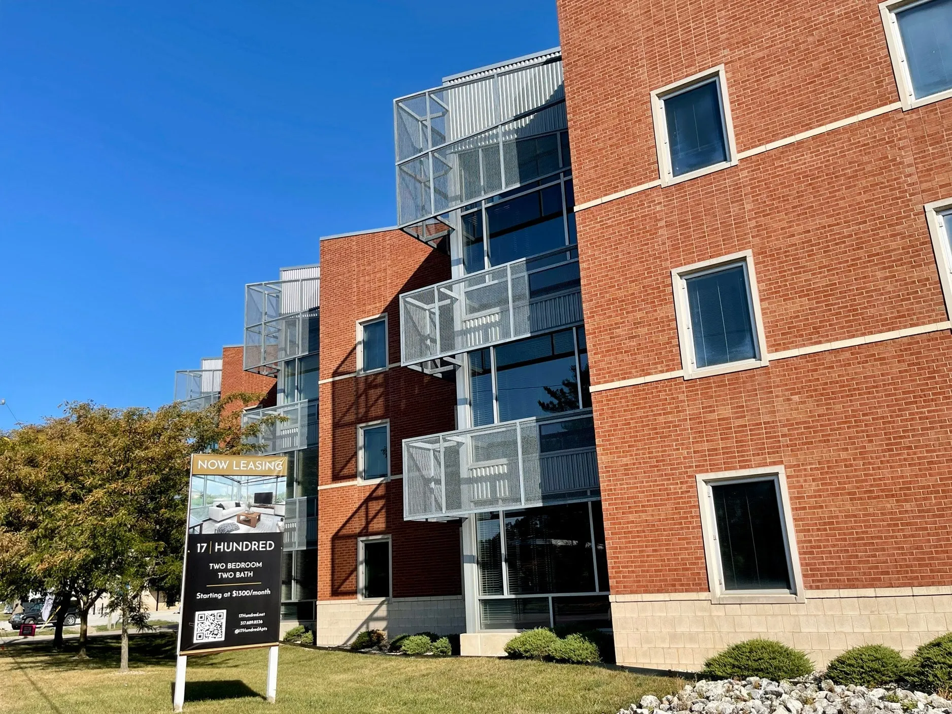 17 Hundred, a four-story red brick building with steel-and-glass balconies